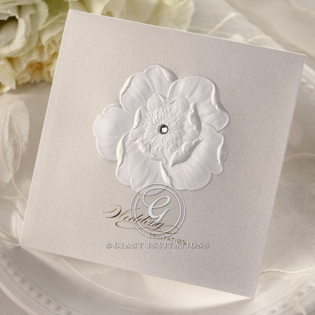 Light cream coloured insert card attached to a white card with an embossed charming flower adorned with a sparkling crystal
